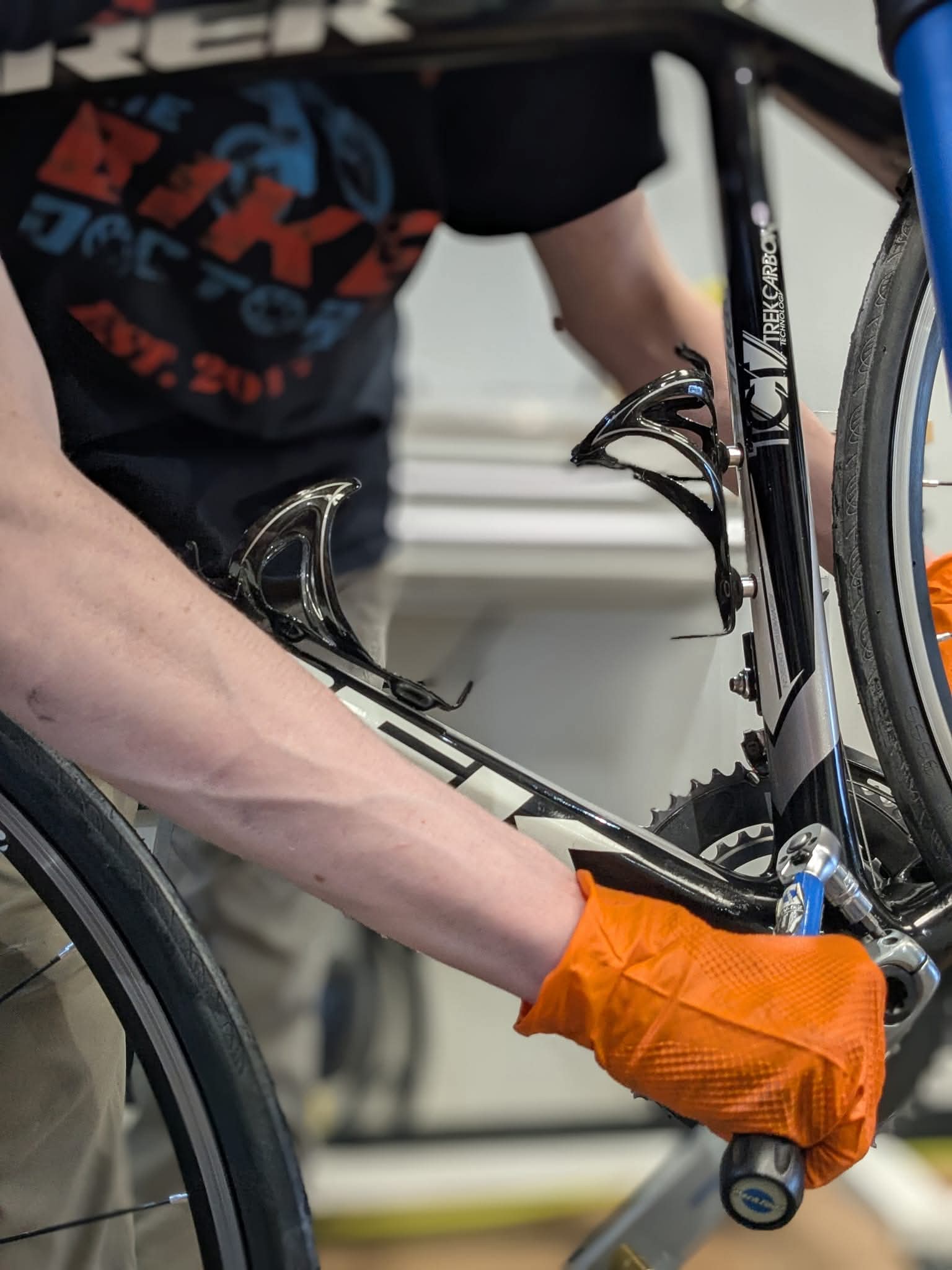 Bike Doctor technician using a torque wrench on a Trek carbon bike